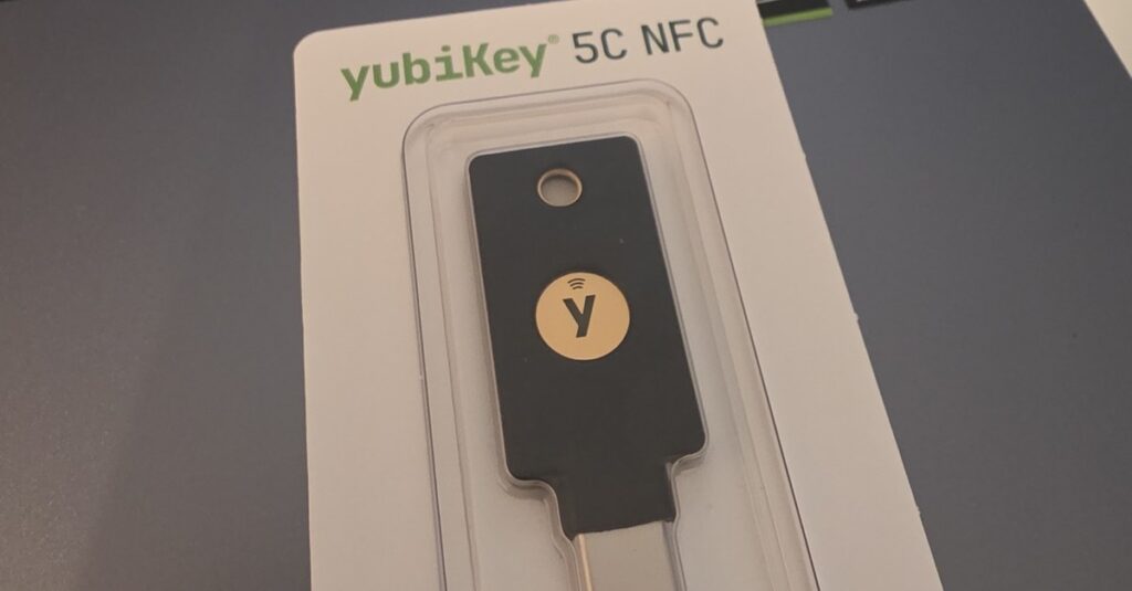 Yubico YubiKey 5C NFC in retail packaging on the ReportedIP development laptop - the hardware key used to test Hive WebAuthn 2FA